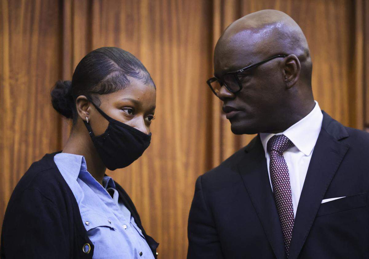 Jahara Malik talks with Kionne McGhee, one of her defense attorneys, on Feb. 6, 2025, at the Richard E. Gerstein Justice Building in Miami.
